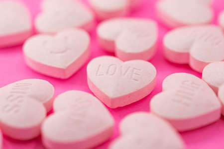 Closed up lot of wording heart shape pink candy, love,hug,kiss,miss, lovely valentine wordingの写真素材