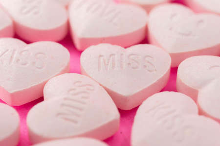 A lot of pink heart candy, Closed up love wording and smiley face for lovely celebration, sweetie pastel valentine backgroundの写真素材