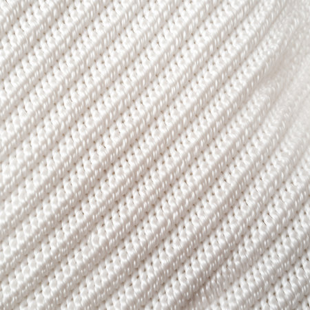 Close-up of textured white woven fabric with irregular raised patternsの素材