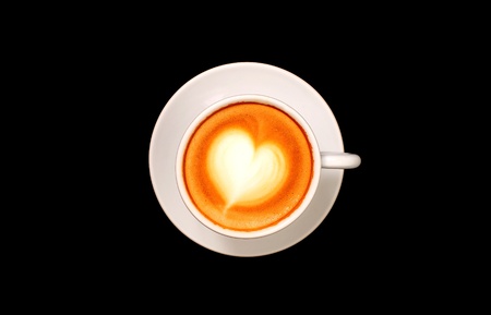 A cup of coffee with heart shaped milk frothの写真素材