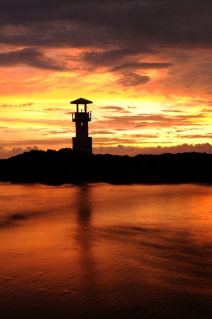 A lighthouse in the sunset skyの写真素材