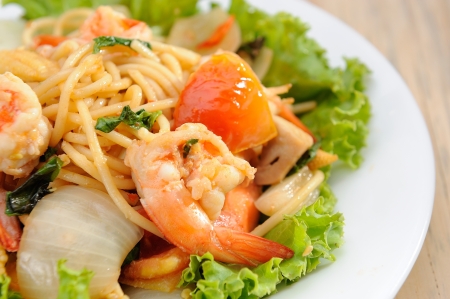 Shrimp spaghetti on white dish and wooden table の写真素材