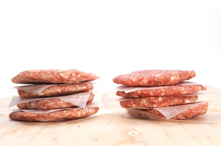 Stack of raw burger on a table の写真素材