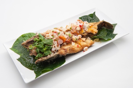 Spicy fried fish served in white dish の写真素材