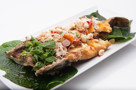 Spicy fried fish served in white dish の写真素材