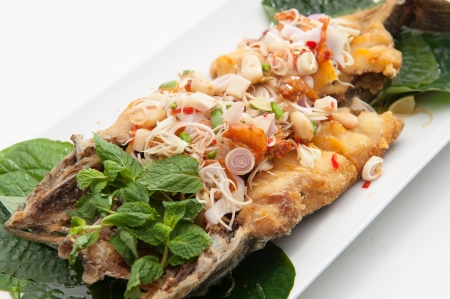 Spicy fried fish served in white dish の写真素材