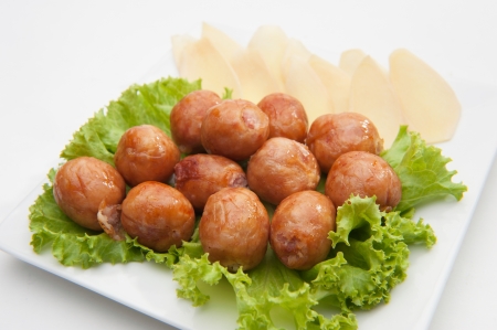 Thai traditional sausages served on white dishの写真素材