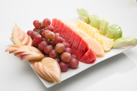 Various fruits served on white dish の写真素材