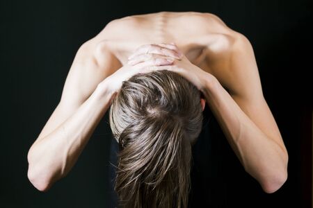 A fragment of the naked body of a young man on a dark backgroundの写真素材