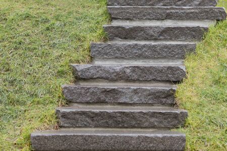 Stone stairs in the Park in the grass near the monumentの写真素材