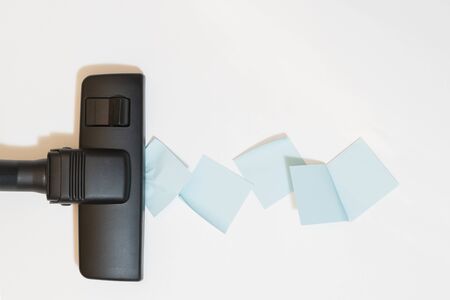 A fragment of a vacuum cleaner removing paper sheetsの写真素材