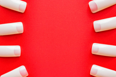 Image of fingernail pads on red background