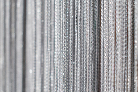 Textured image of a fragment of the curtain on the window