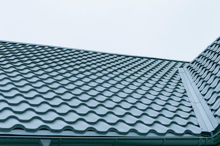 Fragment of the new roof of the house of metal profile