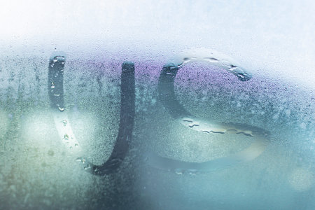 The inscription on the fogged glass in rainy weather, us