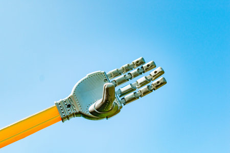 Toy robot hand on sky background