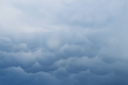 Frowning clouds in the evening sky at sunsetの写真素材