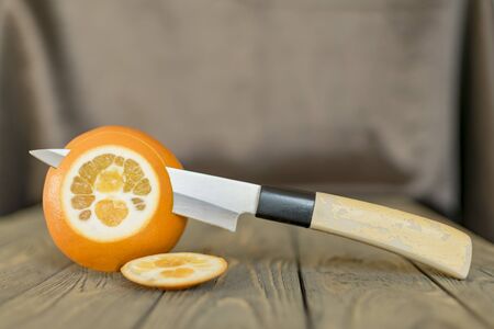 Collage of orange slices and a knife on a decorative backgroundの写真素材