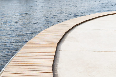 Fragment of a wooden pier on the embankment