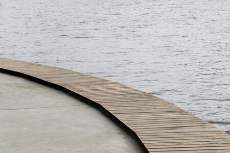 Fragment of a wooden pier on the embankmentの写真素材