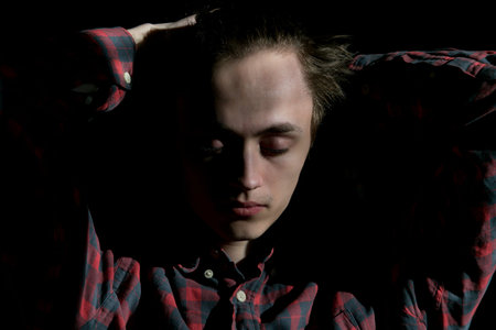 Portrait photo of a young man on a dark background