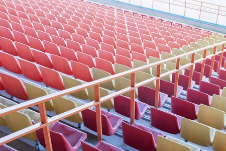 View of the seats of the stands in an empty stadiumの写真素材