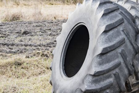 Old big tires for tractors are near the shedの写真素材