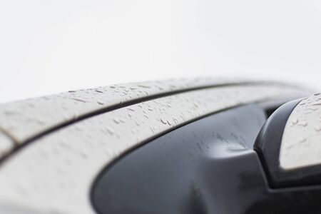 Fragment of a car element with water drops after rainの写真素材