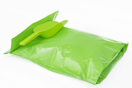  Sealed packaging bag for transporting goods and ladle for filling on a white backgroundの写真素材