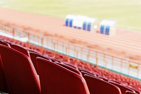 View of the seats of the stands in an empty stadiumの写真素材