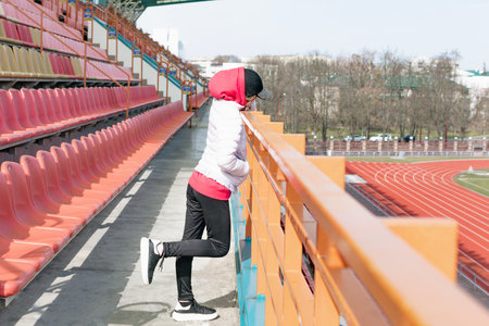 A young girl on the podium of an empty stadium