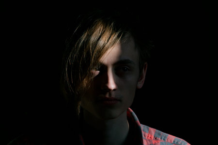 Portrait photo of a young man on a dark background