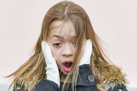 Young girl in white protective gloves on the streetの写真素材