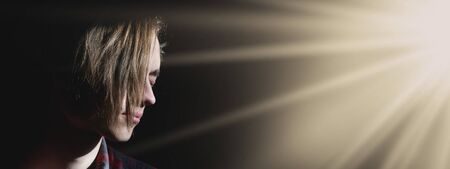 Portrait photo of a young man on a dark backgroundの写真素材
