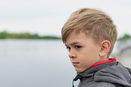 A small boy walks along the embankment in the city Park