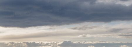 Frowning clouds in the evening sky at sunsetの写真素材