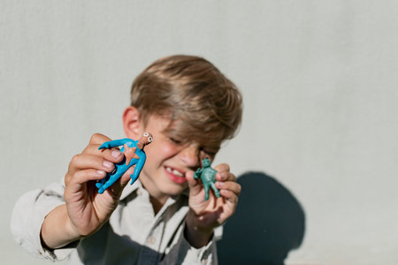 A little boy plays and shows his plasticine crafts