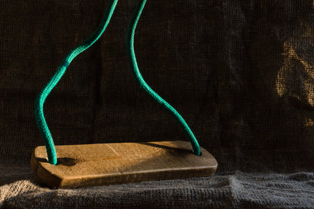Children's wooden swing made with their own hands on the background of burlap