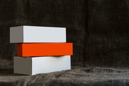 Small packing boxes on a dark burlap background