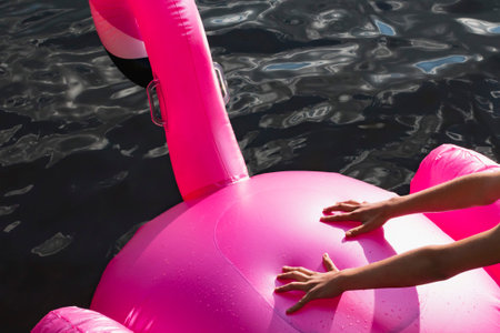 A child tries to climb on an inflatable Flamingo