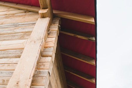 Fragment of a house under construction made of wooden beams