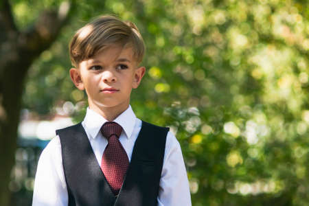 A small boy in full dress uniform in his is preparing for schoolの写真素材