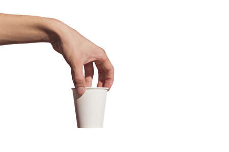 A man's hand holds a disposable paper Cup on a white backgroundの写真素材