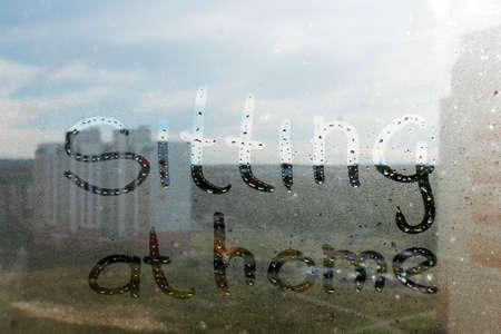 Writing on the fogged glass in the early morning. Sitting at homeの写真素材