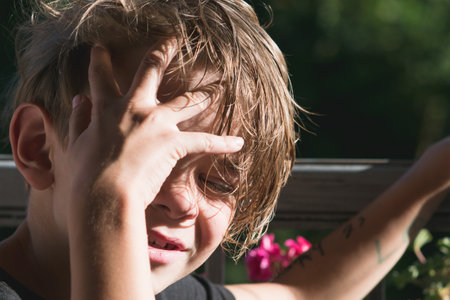 Portrait image of a little boy on a balcony enjoying the sunset raysの写真素材