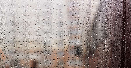 Car glass covered with small drops after rainの写真素材