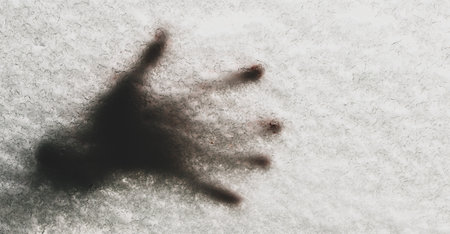Handprints on a snow-covered car window in winter cold weatherの写真素材