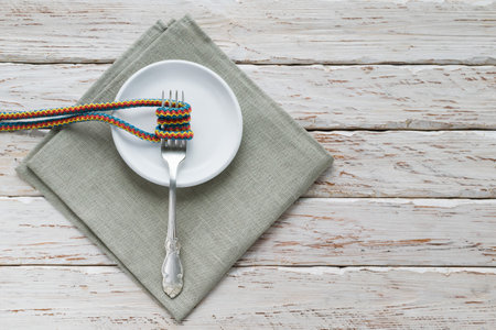 Collage of fork plates, napkins and rope on a decorative backgroundの写真素材