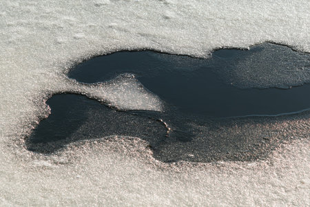 Spring melting of ice and snow on the river on a sunny day