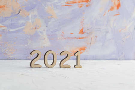 The date 2021 is laid out of wooden numbers on a decorative light backgroundの写真素材